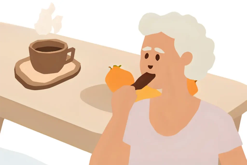 チョコレートと一緒にコーヒーを飲んでいるシニア女性